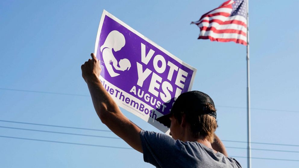 PHOTO: A supporter of the Vote Yes to a Constitutional Amendment on Abortion holds up a sign in Olathe, Kansas, Aug. 01, 2022. 