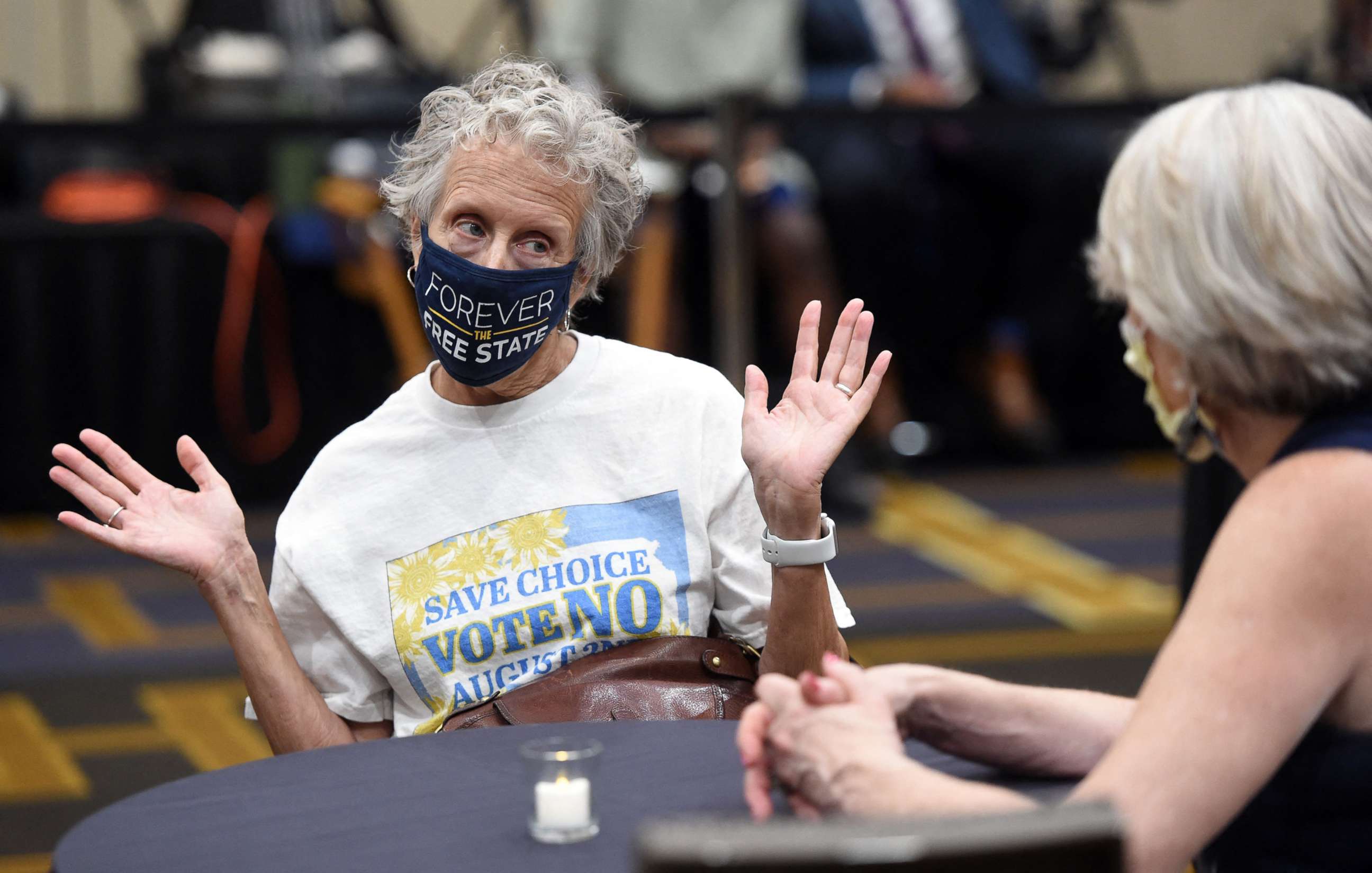 PHOTO: Jeri Swinton wears a mask reading "Forever the Free State" as she talks to friends during the pro-choice Kansas for Constitutional Freedom primary election watch party in Overland Park, Kansas Aug. 2, 2022. 