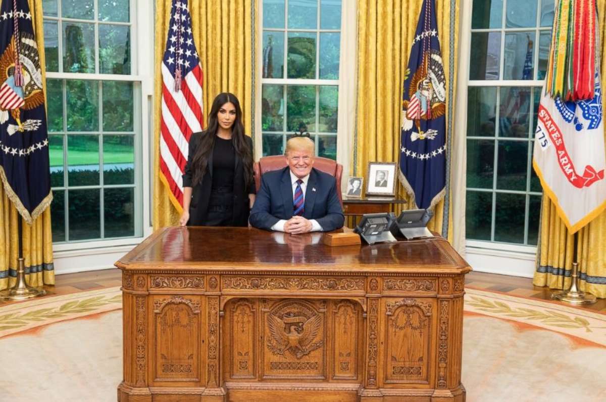 Kim Kardashian West poses with Donald Trump during their meeting in the Oval Office at the White House on Wednesday, May 30, 2018.