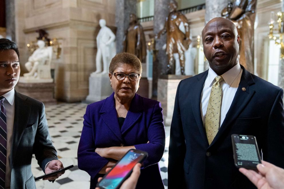 PHOTO: Rep. Karen Bass and Sen. Tim Scott speak briefly to reporters as they exit the office of Rep. James Clyburn following a meeting about police reform legislation on Capitol Hill, May 18, 2021, in Washington, D.C.