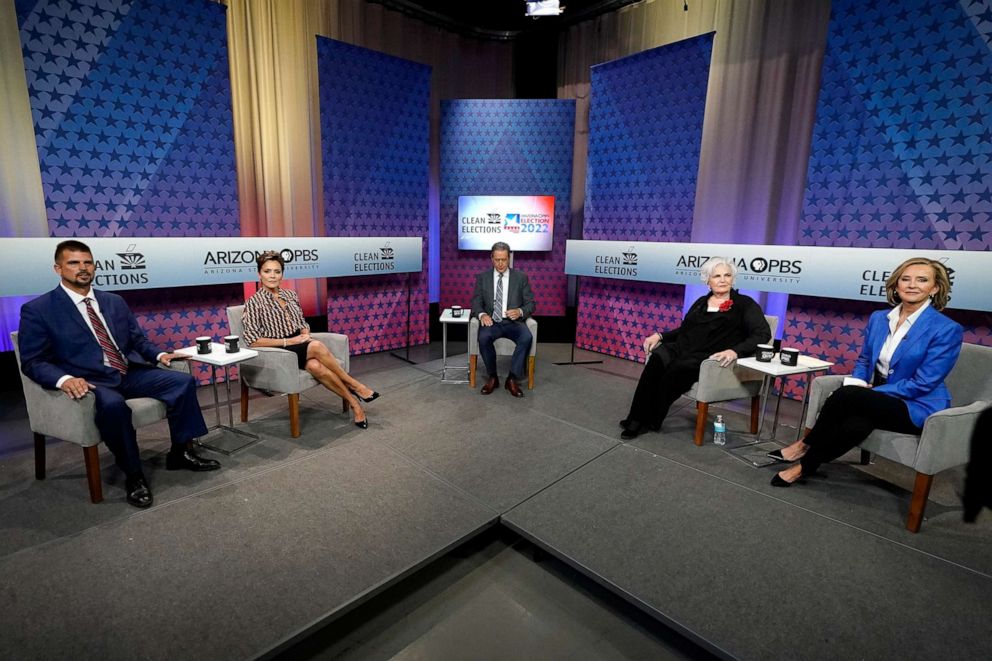 PHOTO: In this June 29, 2022, file photo, Republican candidates for Arizona governor from left to right, Scott Neely, Kari Lake, Paola Tulliani-Zen, and Karrin Taylor Robson, join moderator host Ted Simons, middle, on the set in Phoenix.
