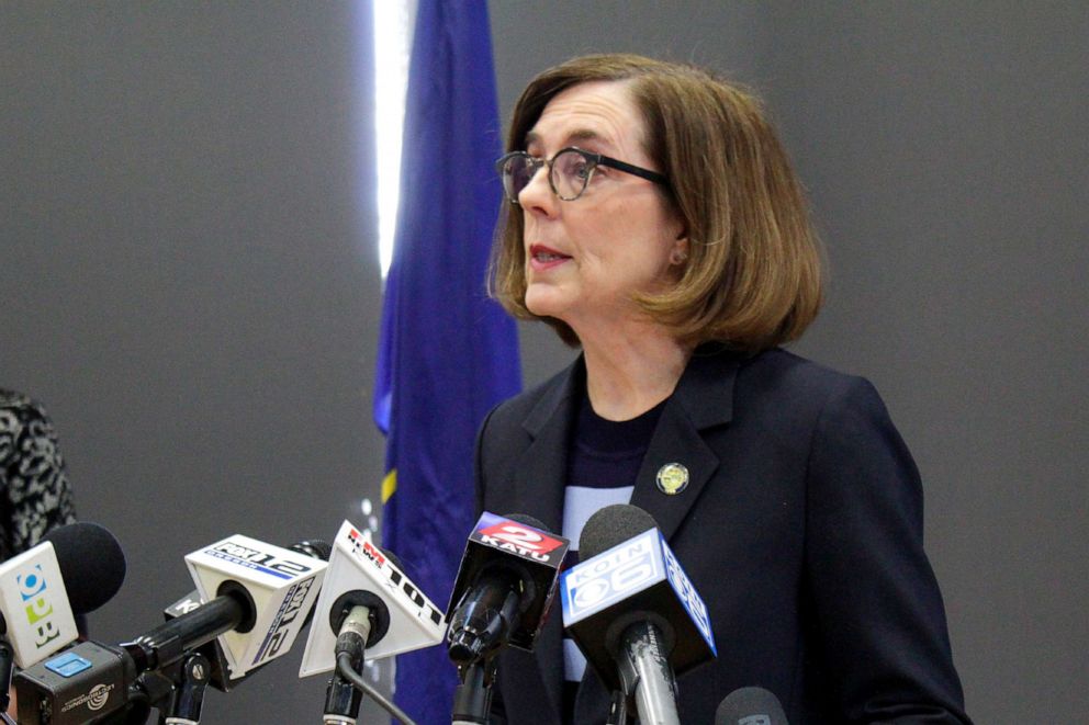 PHOTO: In this March 16, 2020, file photo, Gov. Kate Brown speaks at a news conference to announce a four-week ban on eat-in dining at bars and restaurants due to COVID-19 throughout the state in Portland, Ore.