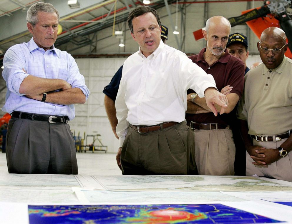 PHOTO: President George W. Bush and Homeland Security Secretary Michael Chertoff (2nd R) get a briefing from Federal Emergency Management Agency (FEMA) chief Michael Brown (C) upon their arrival, Sept. 2, 2005, in Mobile, Ala.