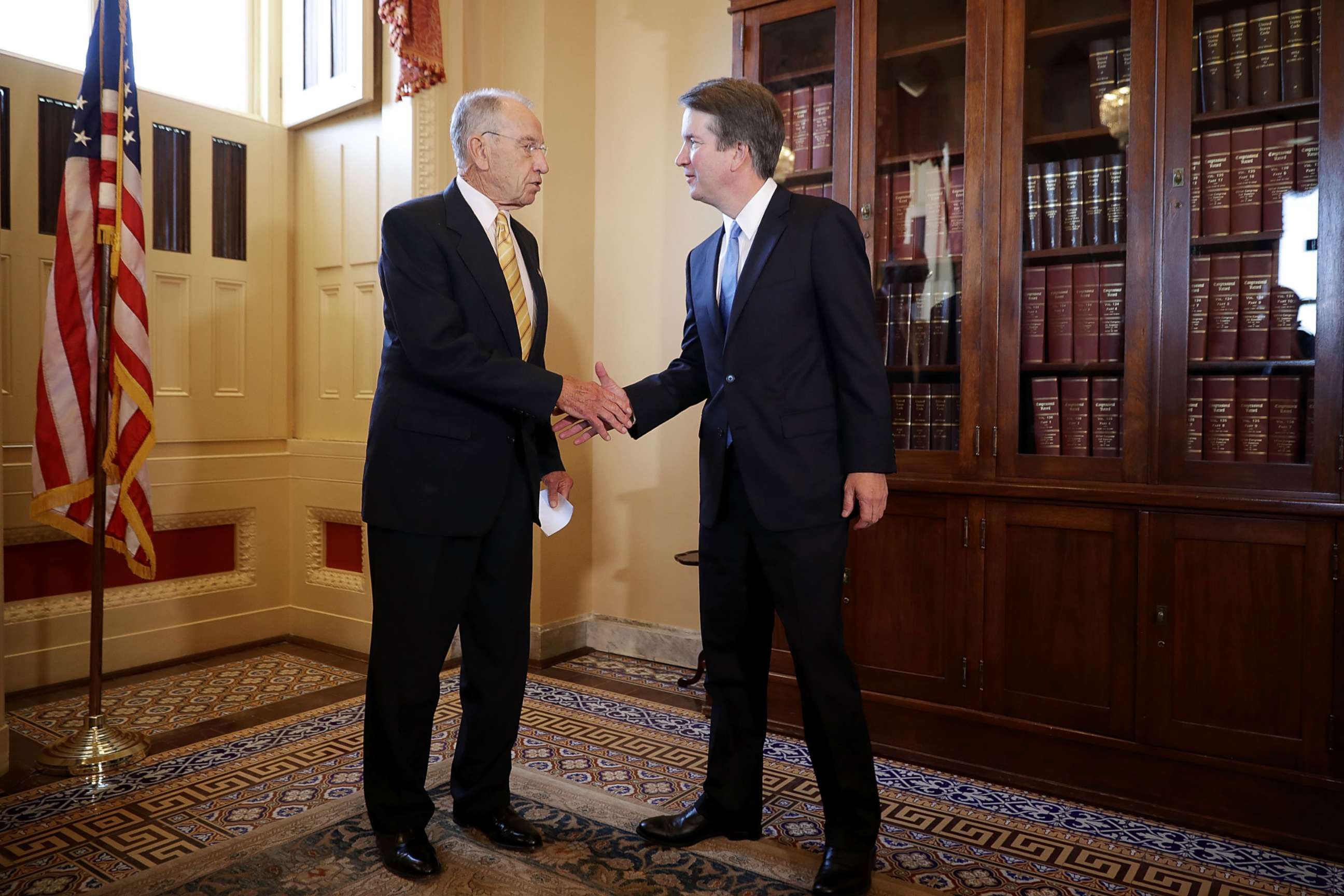 PHOTO: Senate Judiciary Committee Chairman Charles Grassley (R-IA) (L) shakes hands with Judge Brett Kavanaugh after a meeting at the Capitol, July 10, 2018. 