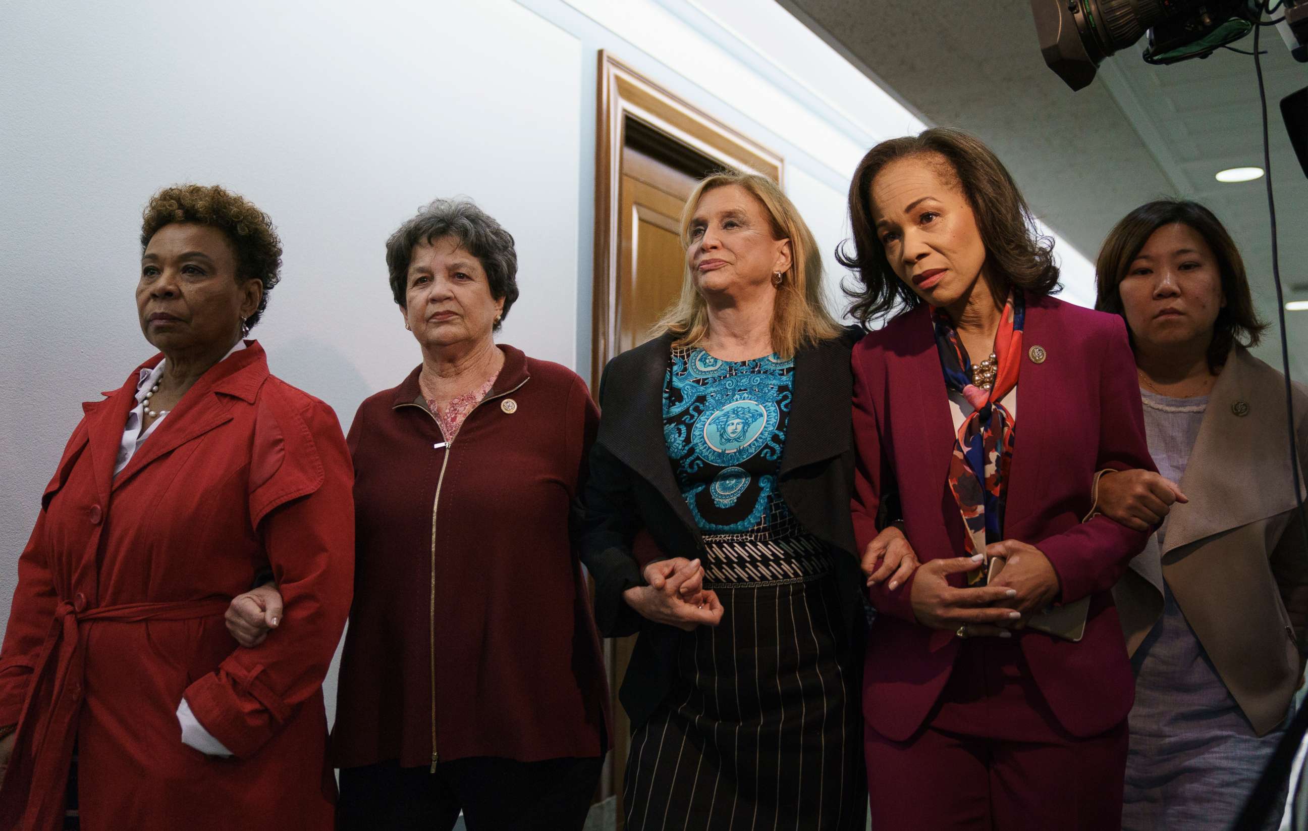 PHOTO: Women members of congress link arms as they walk together and to enter a Senate Judiciary Committee hearing on Judge Brett Kavanaugh, Sept. 28, 2018. 