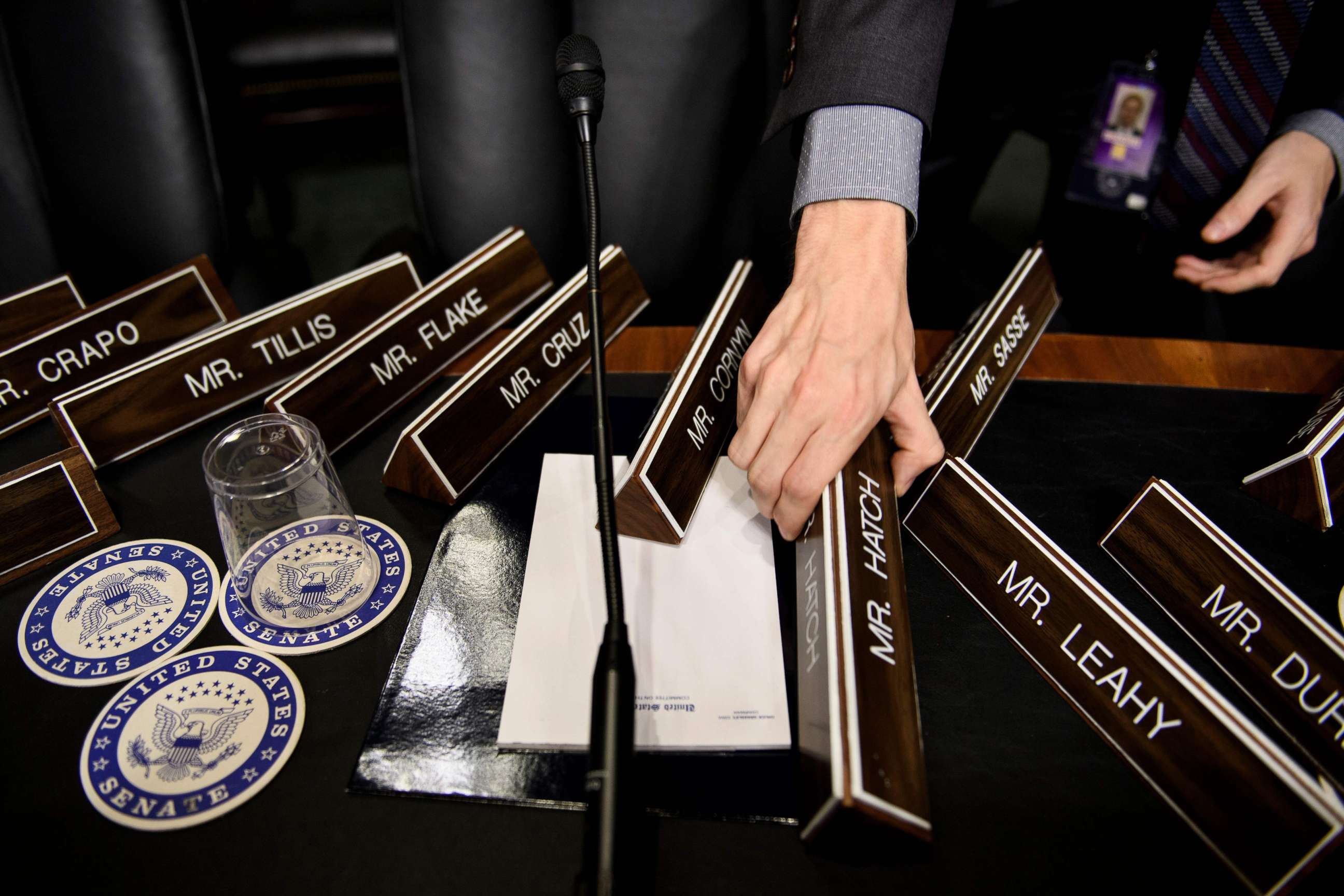 PHOTO: A staff member places name plates as the Senate Judiciary Committee's room  on Capitol Hill, Sept. 26, 2018 in Washington, during preparations one day before the hearing with Blasey Ford and Supreme Court nominee Judge Brett Kavanaugh.