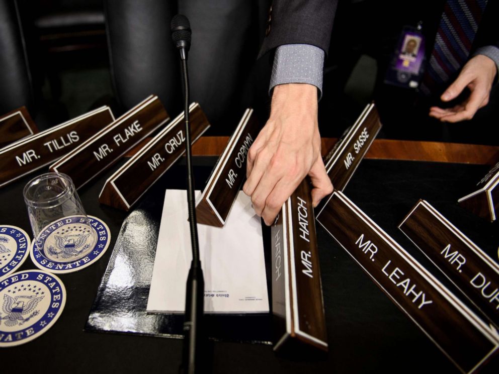 PHOTO: A staff member places name plates as the Senate Judiciary Committees room on Capitol Hill, Sept. 26, 2018 in Washington, during preparations one day before the hearing with Blasey Ford and Supreme Court nominee Judge Brett Kavanaugh.