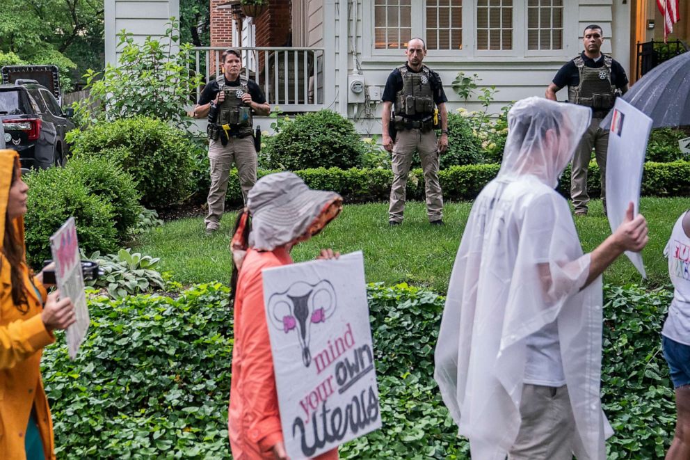 PHOTO: Protesters march past Supreme Court Justice Brett Kavanaugh's home on June 8, 2022 in Chevy Chase, Md.