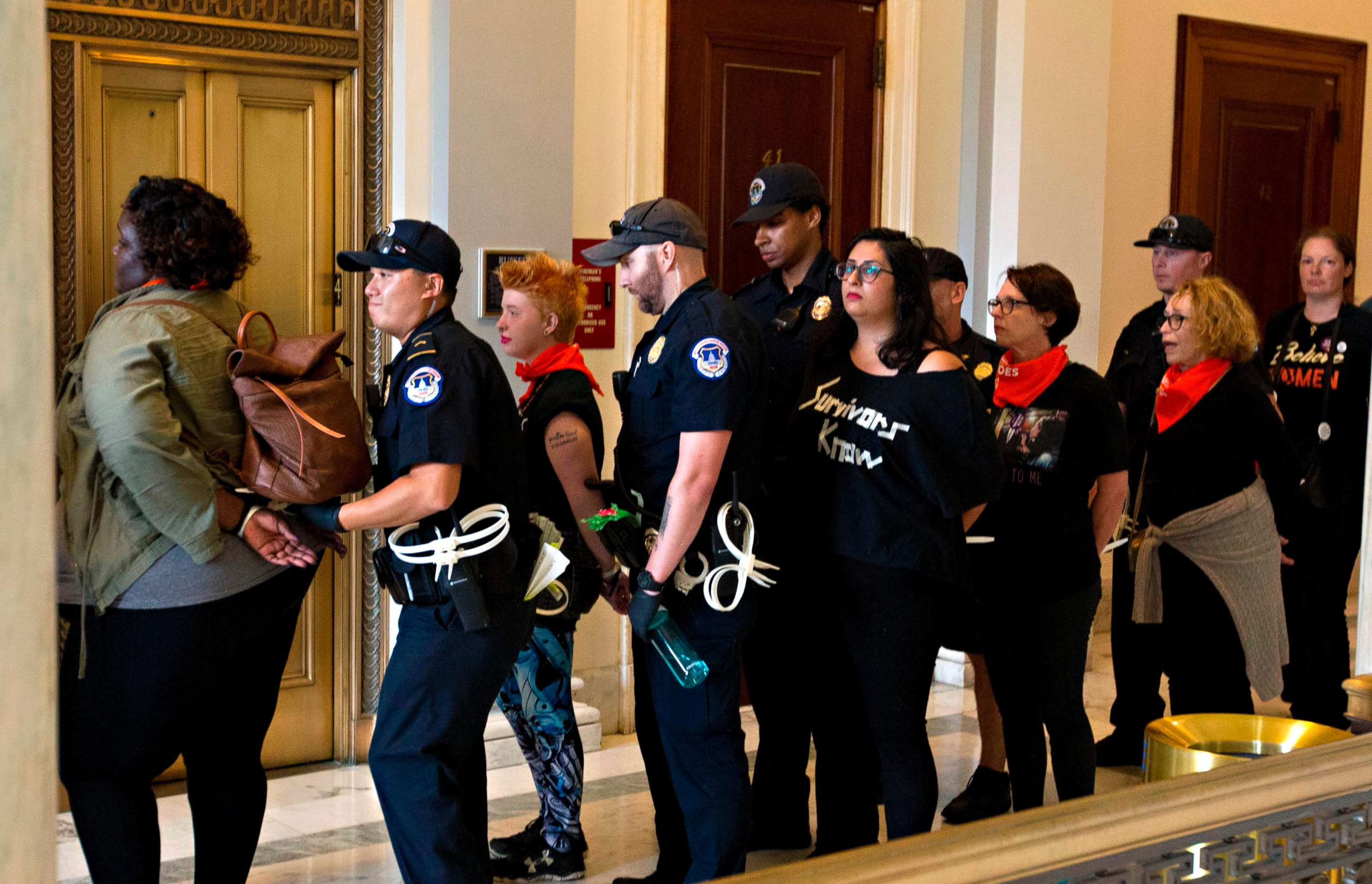 PHOTO: Protesters against US Supreme Court nominee Brett Kavanaugh are arrested after blocking the office of Senator Jeff Flakes, Republican of Arizona, in Washington on Oct. 5, 2018. 