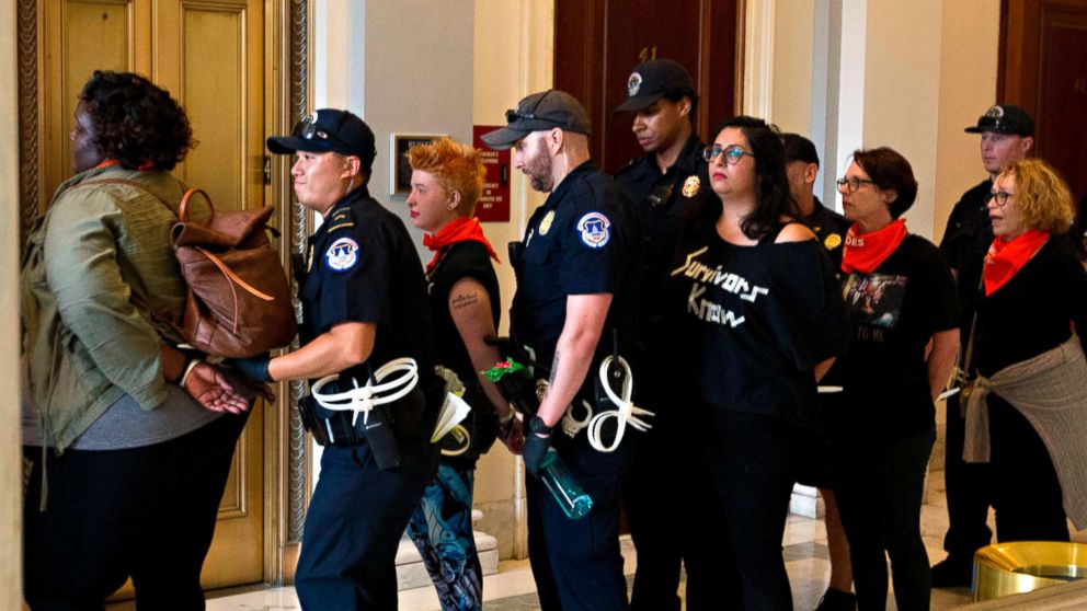 PHOTO: Protesters against US Supreme Court nominee Brett Kavanaugh are arrested after blocking the office of Senator Jeff Flakes, Republican of Arizona, in Washington on Oct. 5, 2018. 