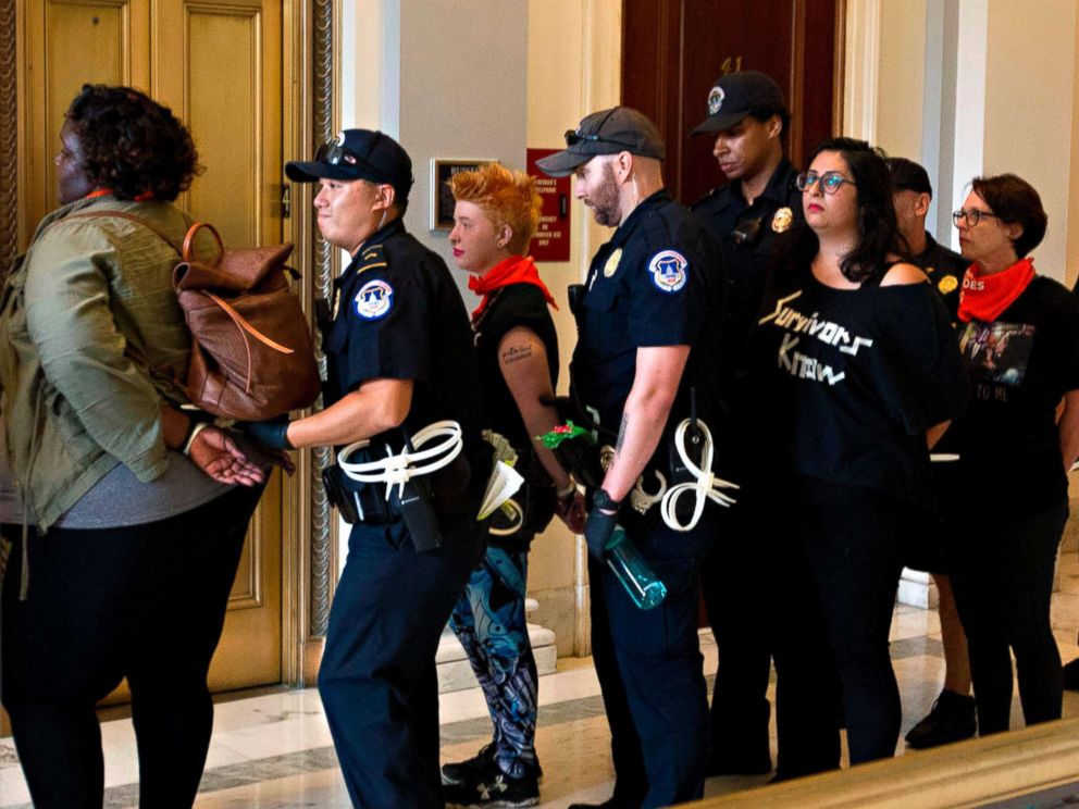 PHOTO: Protesters against US Supreme Court nominee Brett Kavanaugh are arrested after blocking the office of Senator Jeff Flakes, Republican of Arizona, in Washington on Oct. 5, 2018.