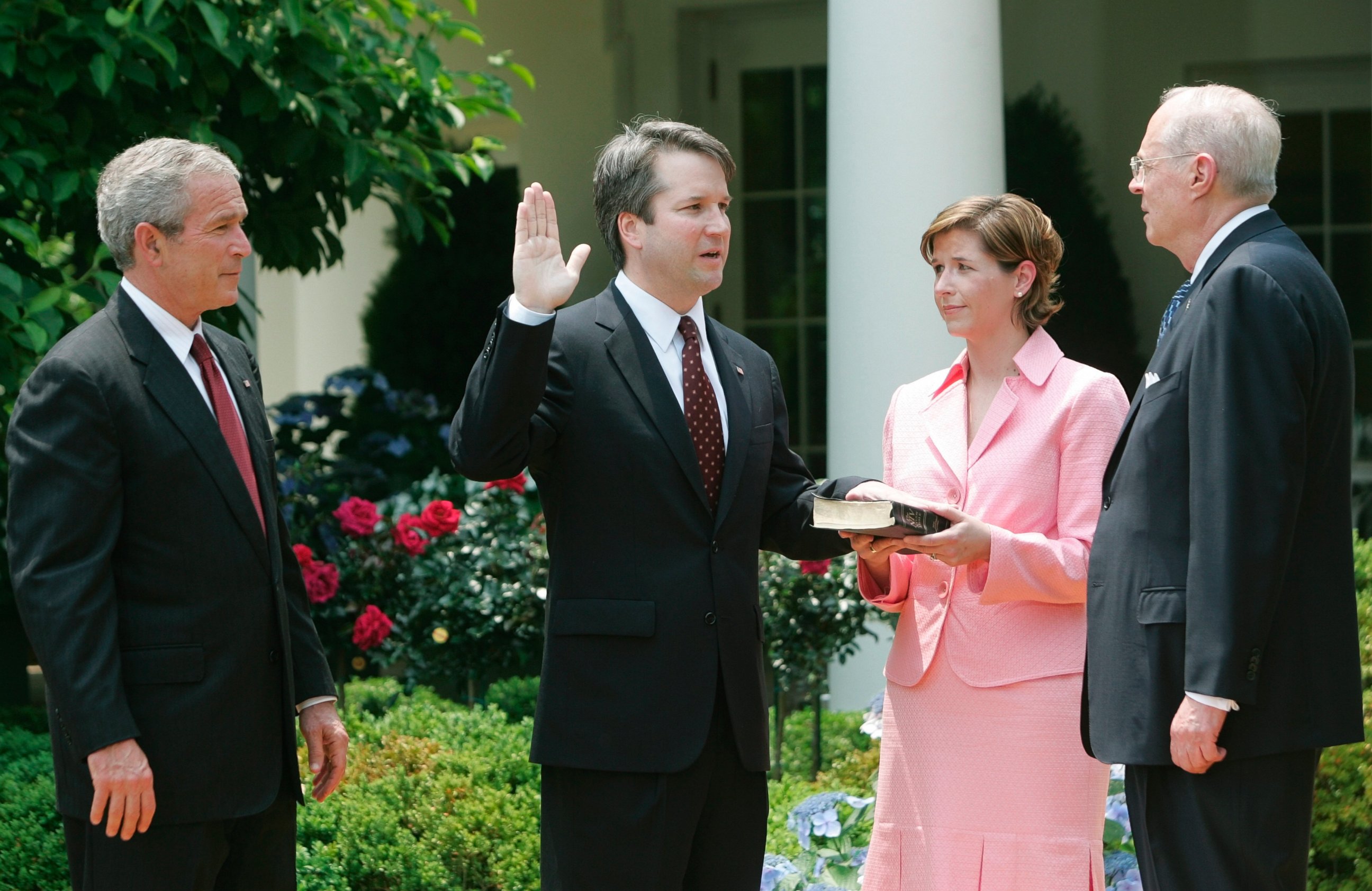 In this June 1, 2006 file photo, from left to right, President Bush, watches the swearing-in of Brett Kavanaugh as Judge for the U.S. Court of Appeals for the District of Columbia by U.S.