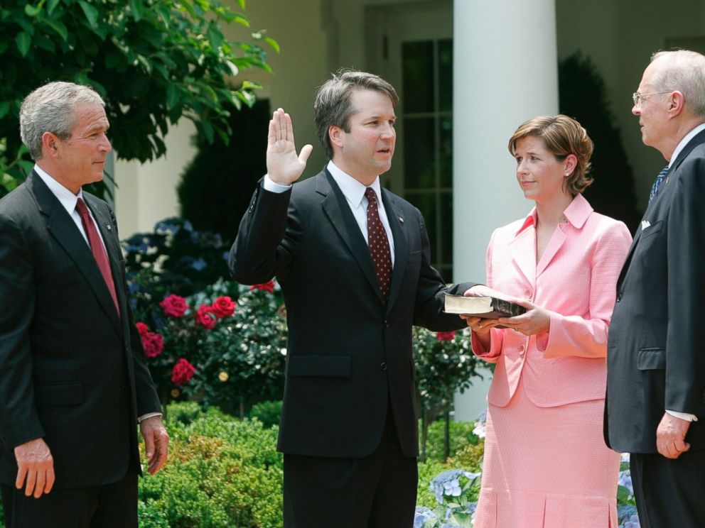 In this June 1, 2006 file photo, from left to right, President Bush, watches the swearing-in of Brett Kavanaugh as Judge for the U.S. Court of Appeals for the District of Columbia by U.S.