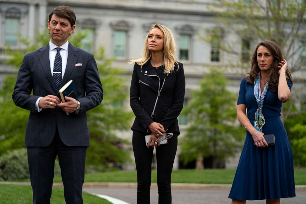 PHOTO: White House staffers Hogan Gidley, Kayleigh McEnany and Alyssa Farah listen as lawmakers talk about the coronavirus spending bill after meeting with President Donald Trump at White House, April 21, 2020, in Washington.