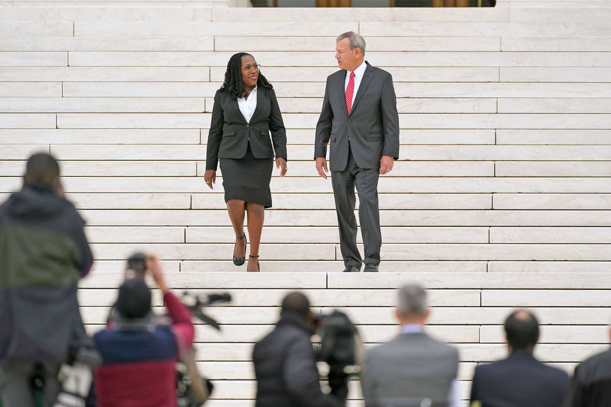 PHOTO: US Supreme Court Justice Ketanji Brown Jackson speaks with Chief Justice John Roberts on the steps of the US Supreme Court, immediately following the investiture ceremony of Justice Jackson, in Washington, D.C, Sept. 30, 2022.
