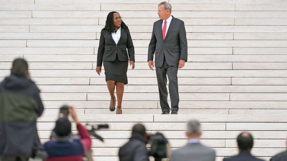 PHOTO: US Supreme Court Justice Ketanji Brown Jackson speaks with Chief Justice John Roberts on the steps of the US Supreme Court, immediately following the investiture ceremony of Justice Jackson, in Washington, D.C, Sept. 30, 2022.