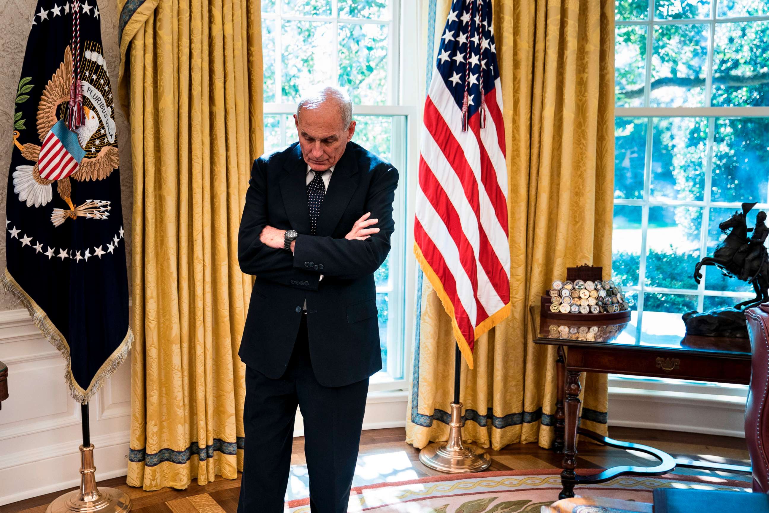 PHOTO: White House Chief of Staff John Kelly waits while Governor of Puerto Rico Ricardo Rossello and President Donald Trump make statement to the press before a meeting  in the Oval Office of the White House, Oct. 19, 2017.