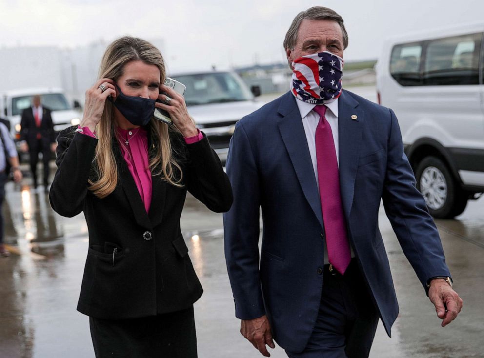 PHOTO: In this July 15, 2020, file photo, Senators Kelly Loeffler and David Perdue wear protective face masks as they walk together at Hartsfield-Jackson Atlanta International Airport following the arrival of President Donald Trump in Atlanta.