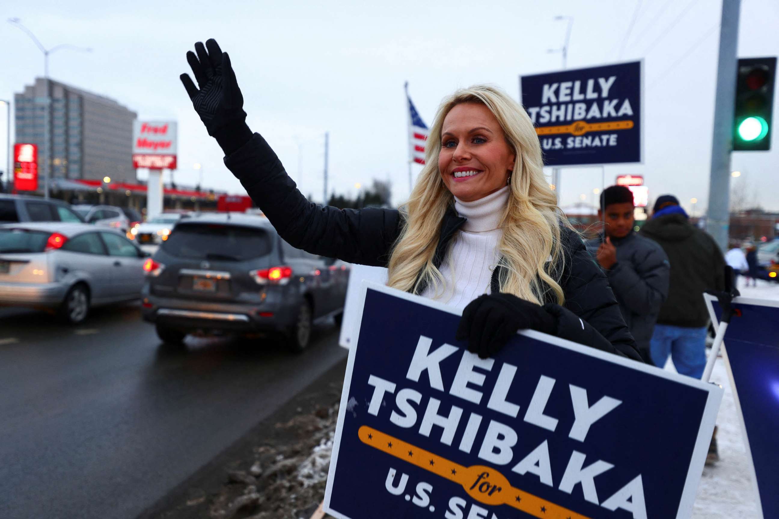 PHOTO: U.S. Senate candidate Kelly Tshibaka waves to motorists on U.S. election night on the corner of Seward Highway and Northern Lights Boulevard, Anchorage, Alaska, Nov. 8, 2022.