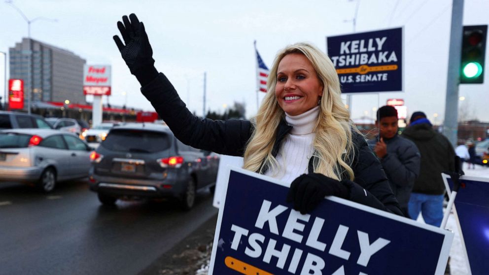 PHOTO: U.S. Senate candidate Kelly Tshibaka waves to motorists on U.S. election night on the corner of Seward Highway and Northern Lights Boulevard, Anchorage, Alaska, Nov. 8, 2022.