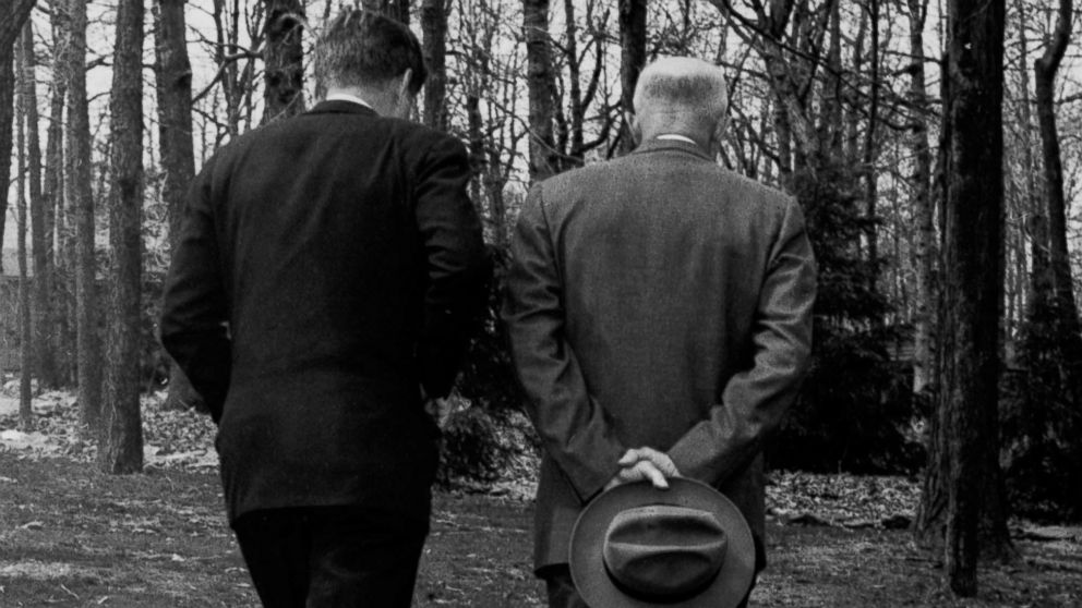 PHOTO: President John F. Kennedy and former President Dwight D. Eisenhower walk along a path at Camp David in Maryland on April 22, 1961, as the two met to discuss the failed Bay of Pigs invasion.