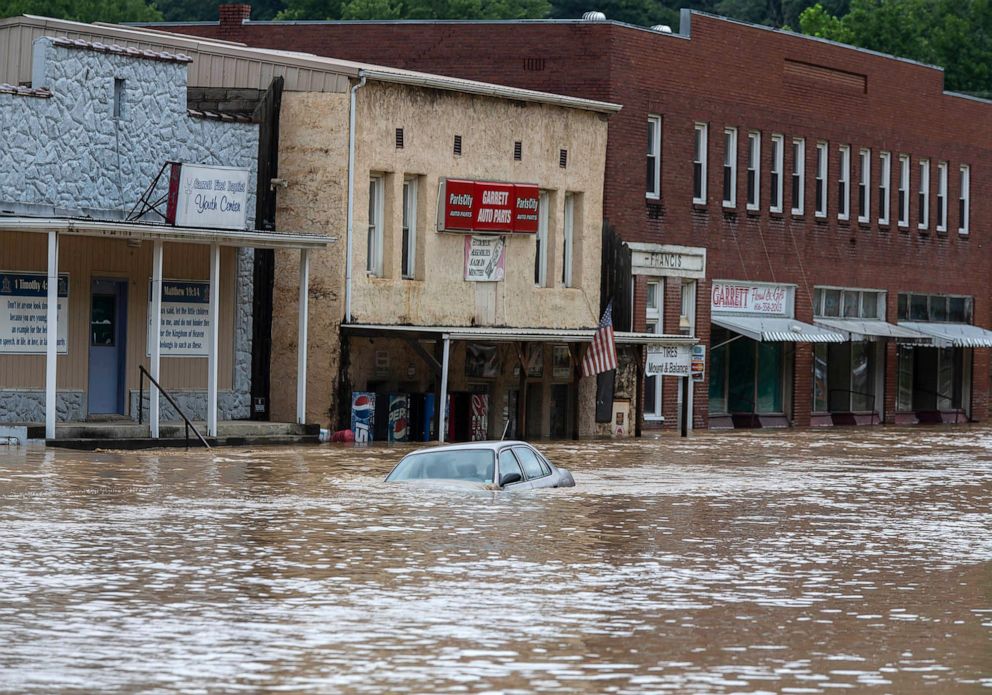 PHOTO: A car is submerged in flood waters along Right Beaver Creek following a day of heavy rain, on July 28, 2022, in Garrett, Ky.