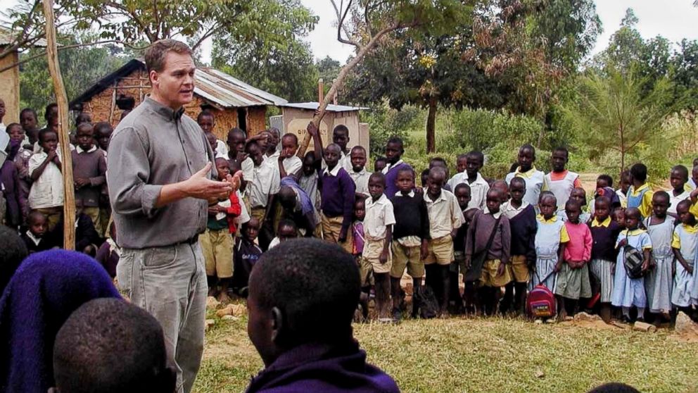 Professor Barrett speaking with a group of schoolchildren in Kenya.
