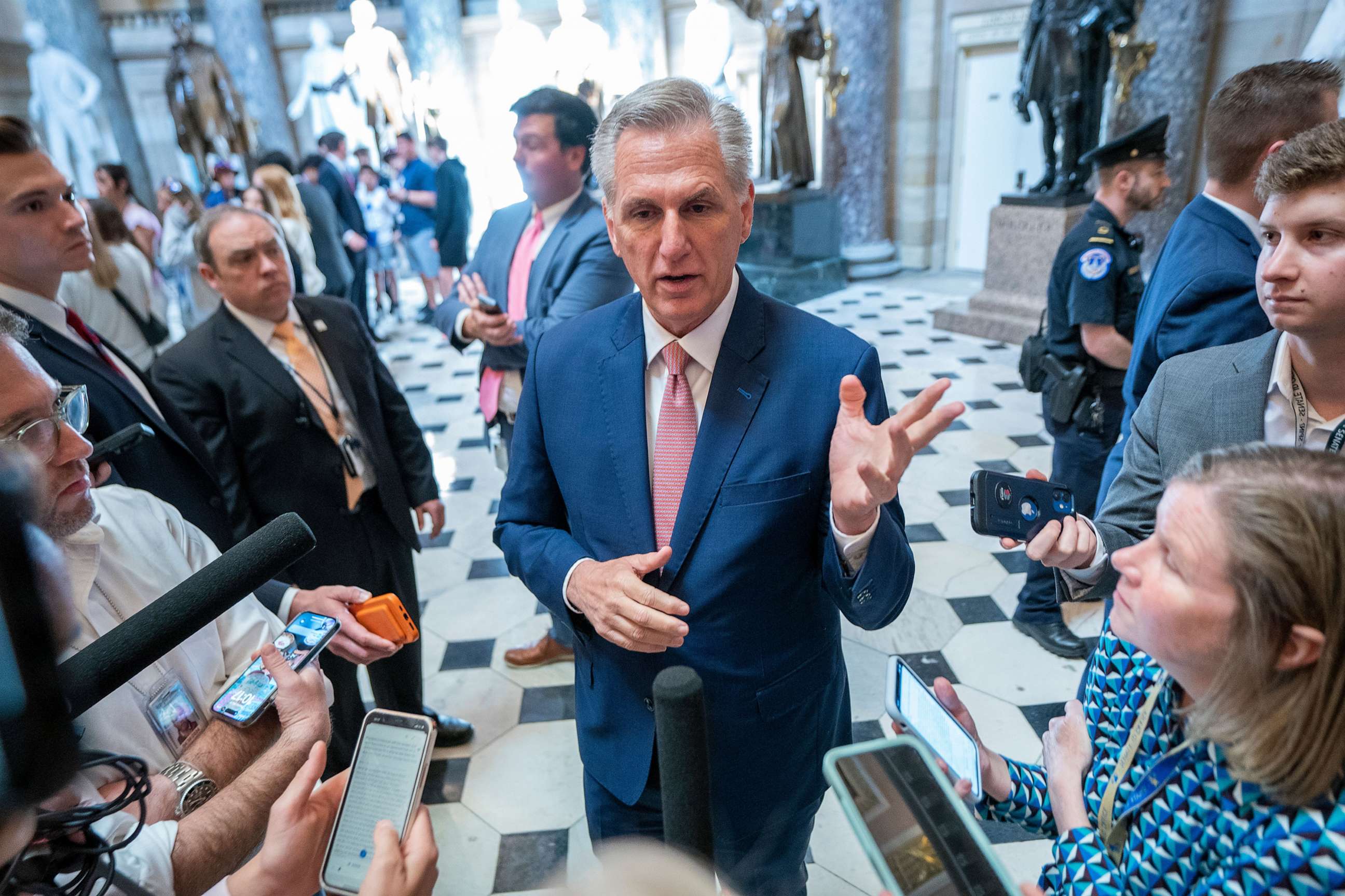 PHOTO: Speaker of the House Kevin McCarthy responds to a question from the news media during an impromptu question and answer session in Statuary Hall of the US Capitol, May 18, 2023, in Washington.