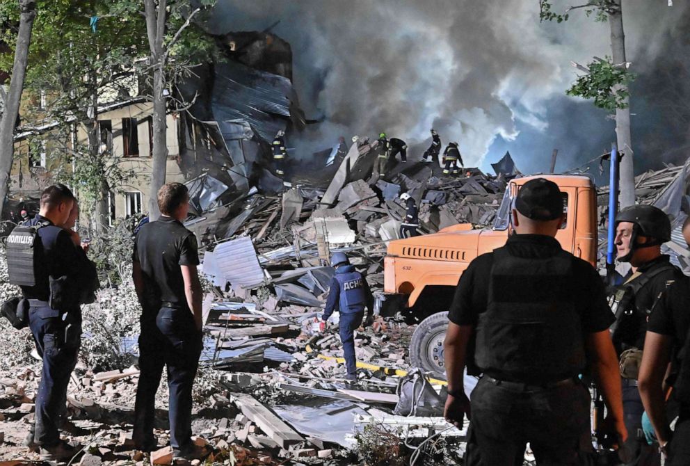 PHOTO: Rescue workers inspect the site of a destroyed hostel, after a missile strike hit the city Kharkiv, Ukraine, Aug. 17, 2022.