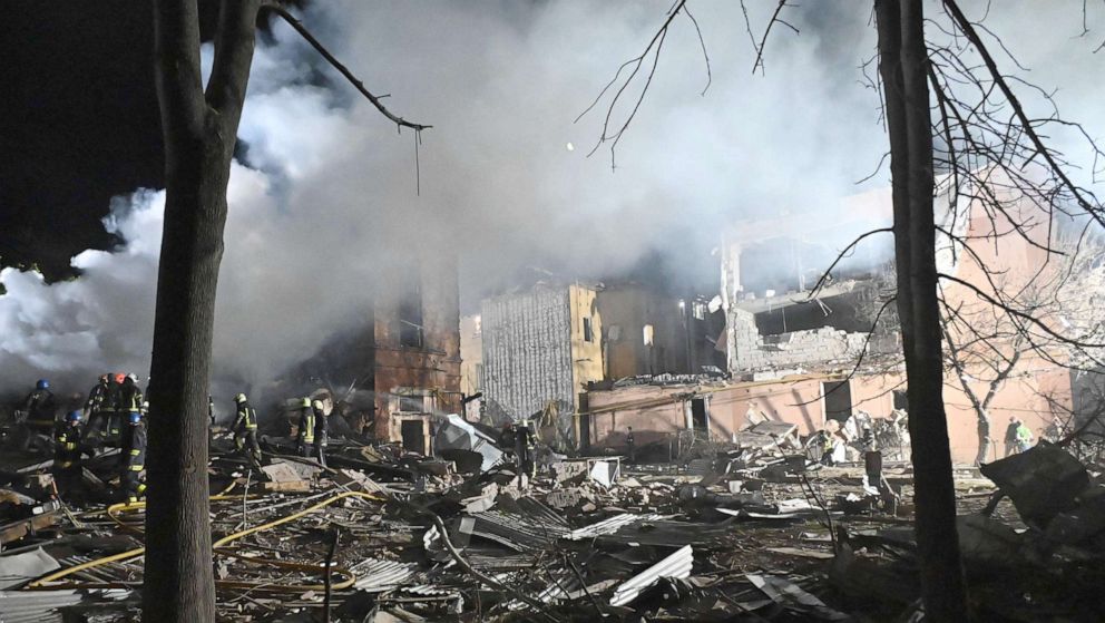 PHOTO: Rescue workers and firefighters work at the site of a destroyed hostel, after a missile strike hit the city Kharkiv, Ukraine, Aug. 17, 2022.