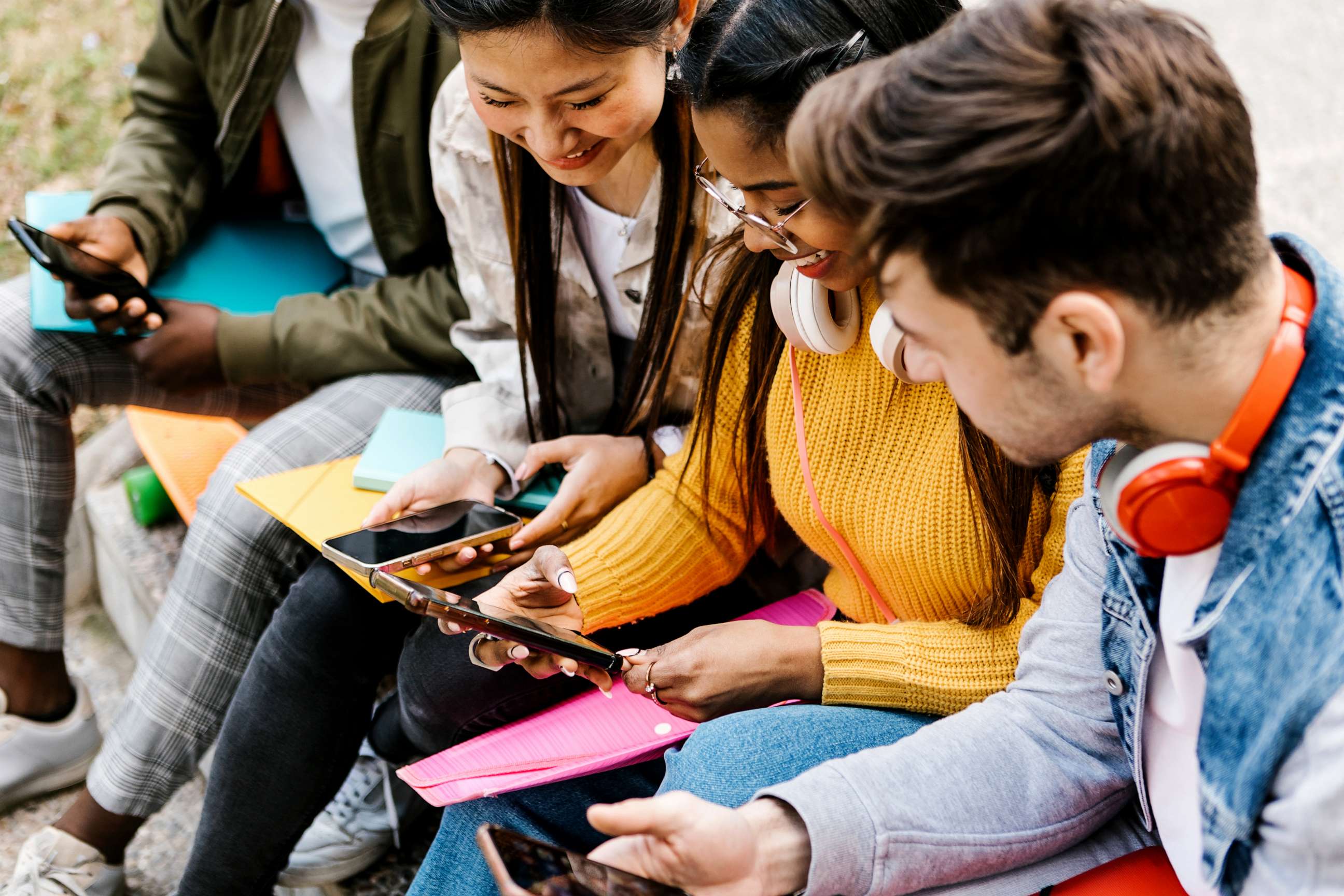 PHOTO: In this stock photo, teens are shown looking at their phones.