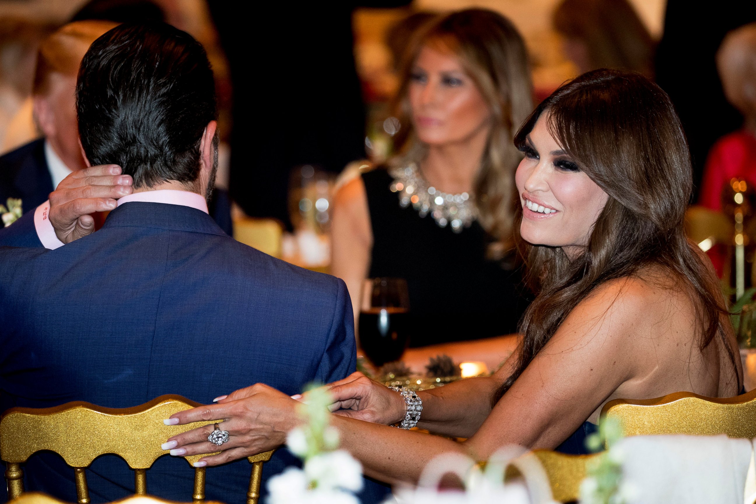 PHOTO: Kimberly Guilfoyle, right, and Donald Trump Jr., the son of President Donald Trump, left, sit with President Donald Trump, background left, and first lady Melania Trump, center, at Mar-a-lago in Palm Beach, Fla., Tuesday, Dec. 24, 2019.
