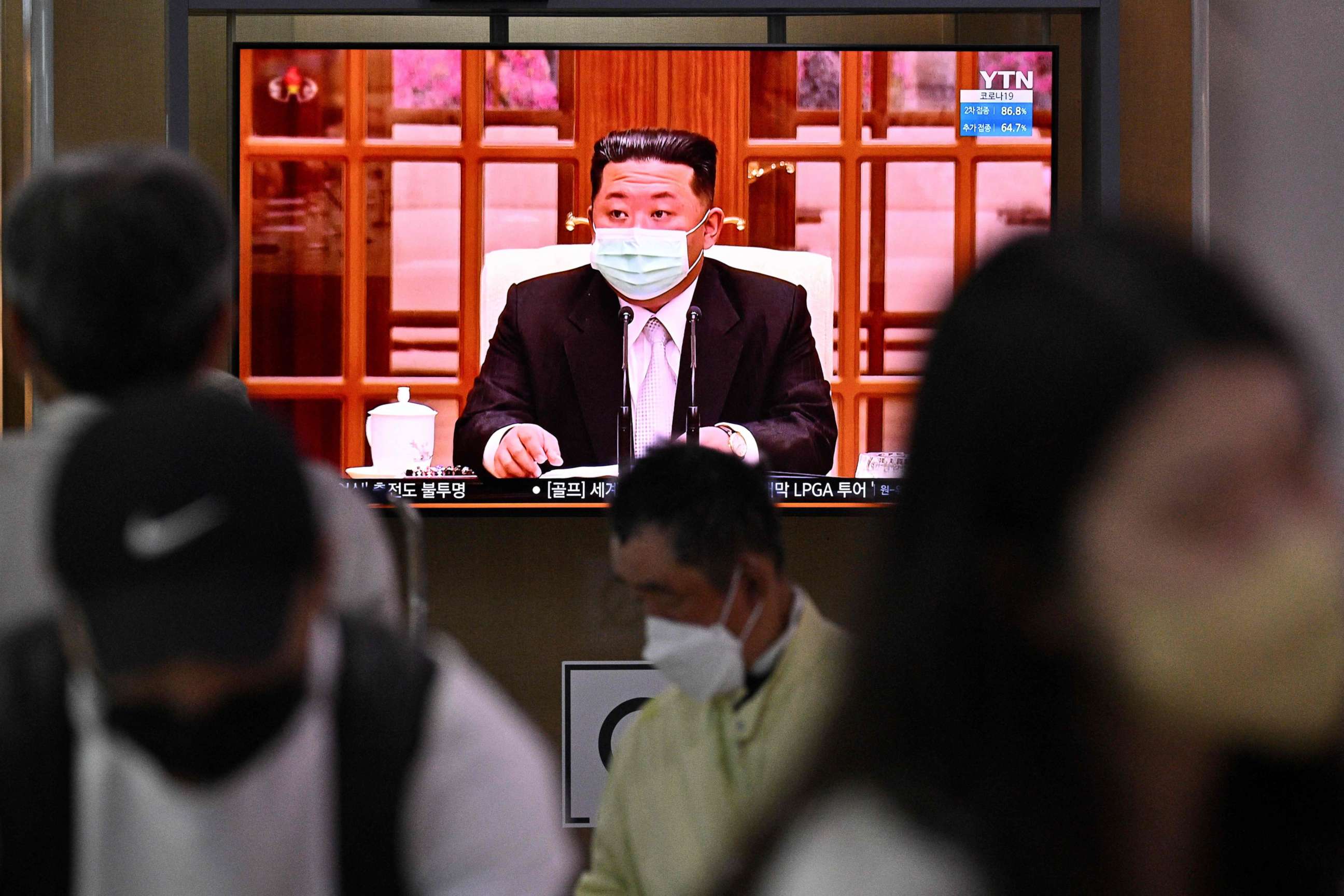 PHOTO: People sit near a screen showing a news broadcast at a train station in Seoul on May 12, 2022