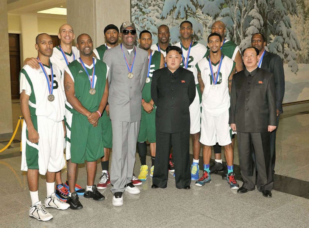 PHOTO: Former U.S. basketball star Dennis Rodman (3rd from L, front row) and other American basketball players pose for photos with North Korean leader Kim Jong Un (3rd from R, front row) at the Pyongyang Indoor Stadium, Jan. 8, 2014.