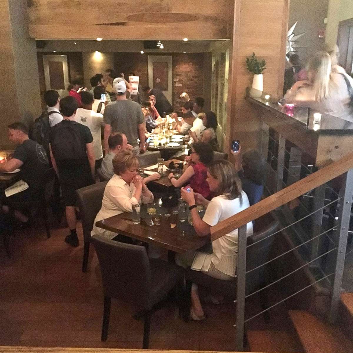 PHOTO: In this photo obtained from social media, activists chant slogans as they interrupt U.S. Homeland Security Secretary Kirstjen Nielsen's (top R) dinner at a restaurant in Washington, D.C., June 19, 2018.