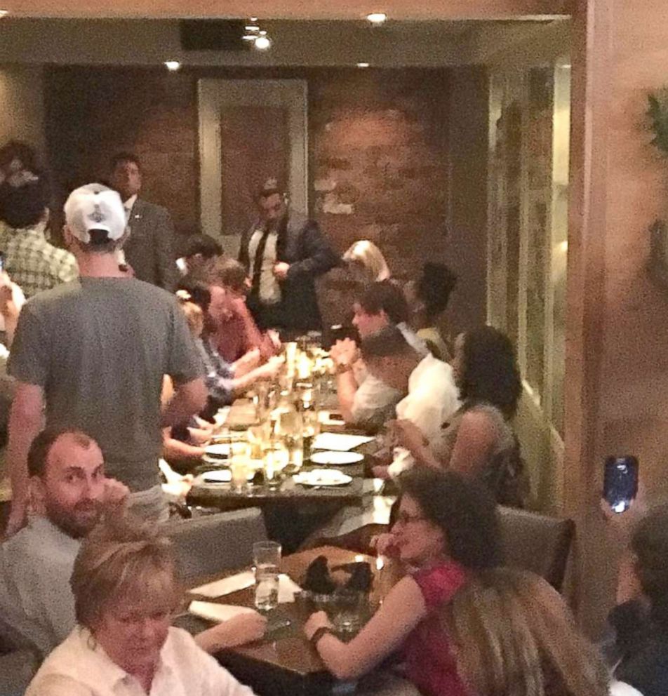 PHOTO: Activists chant slogans as they interrupt U.S. Homeland Security Secretary Kirstjen Nielsen's (top R) dinner at a restaurant in Washington, D.C., June 19, 2018, in this photo obtained from social media.