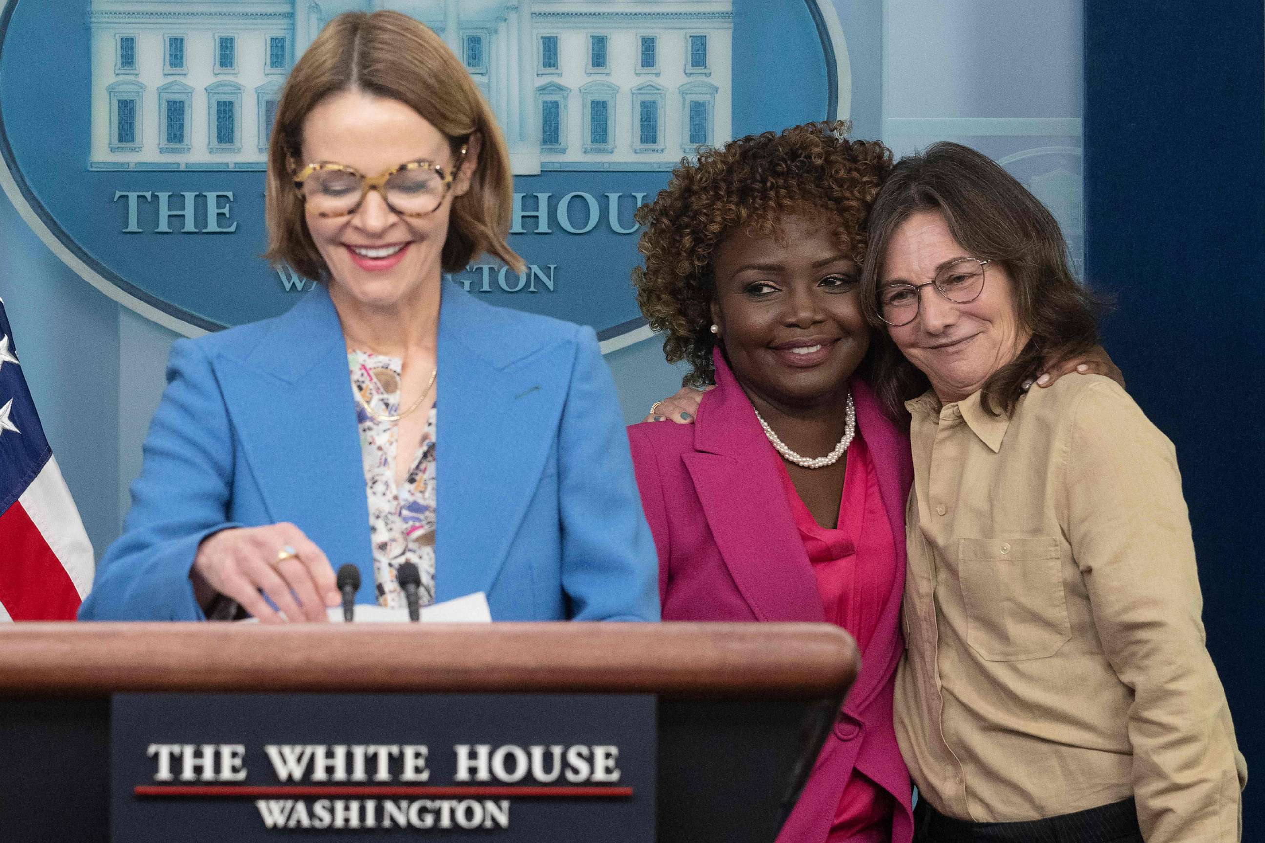 PHOTO: White House Press Secretary Karine Jean-Pierre is hugged by television producer Ilene Chaiken (R) as actress and musician Leisha Hailey (L) speaks during the daily briefing in Washington, D.C., on April 25, 2023.