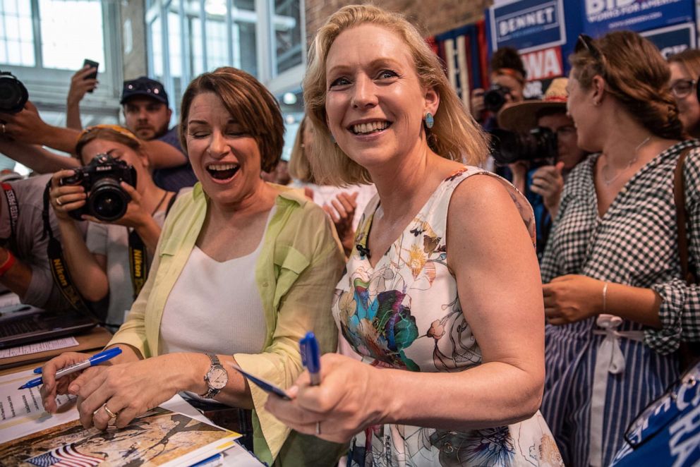 PHOTO: Democratic presidential candidate U.S. Sen. Kirsten Gillibrand surprises Democratic presidential candidate U.S. Sen. Amy Klobuchar at the Iowa Democrats booth at the Iowa State Fair, August 10, 2019 in Des Moines, Iowa.