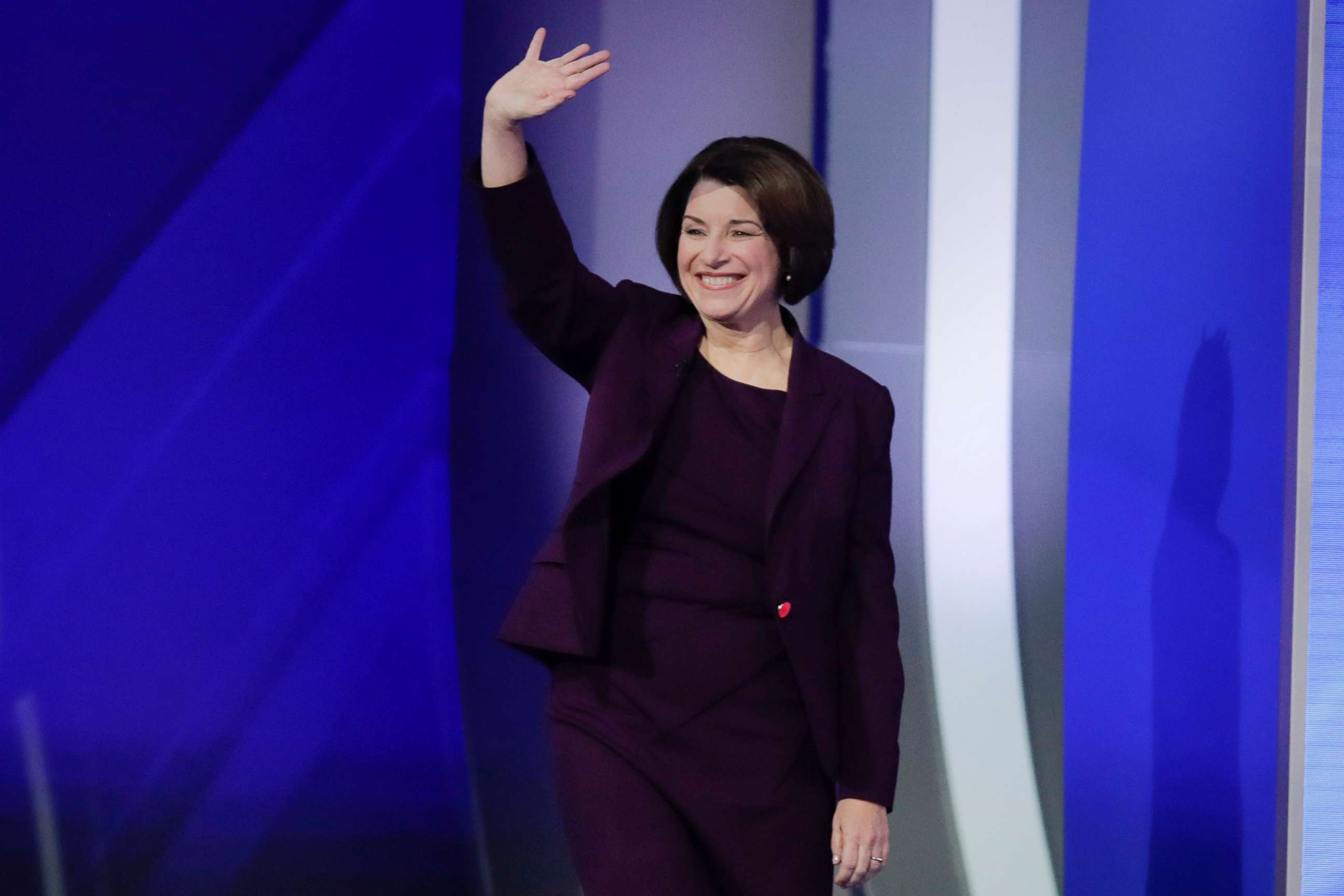 PHOTO: Sen. Amy Klobuchar waves as she walks on stage, Feb. 7, 2020, for the start of a Democratic presidential primary debate at Saint Anselm College in Manchester, N.H.