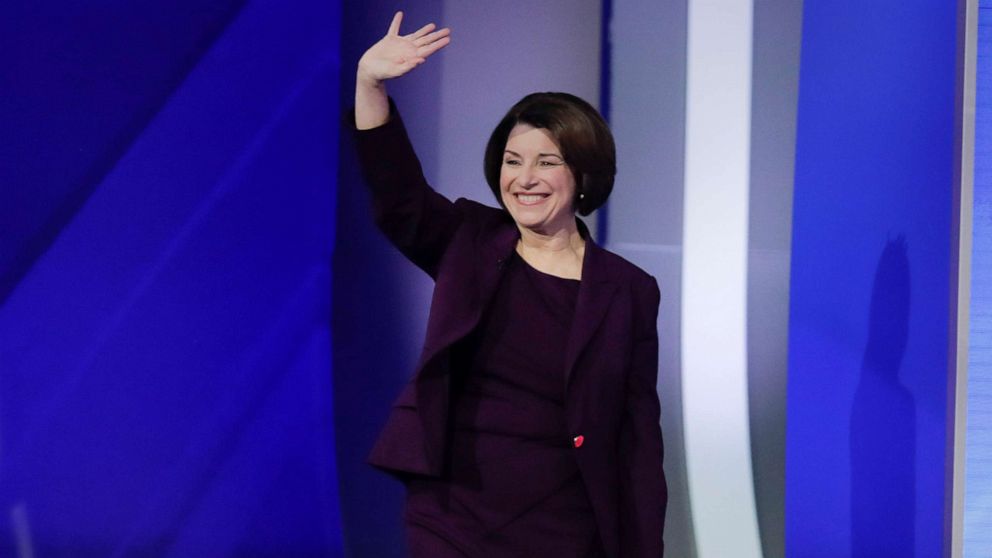 PHOTO: Sen. Amy Klobuchar waves as she walks on stage, Feb. 7, 2020, for the start of a Democratic presidential primary debate at Saint Anselm College in Manchester, N.H.