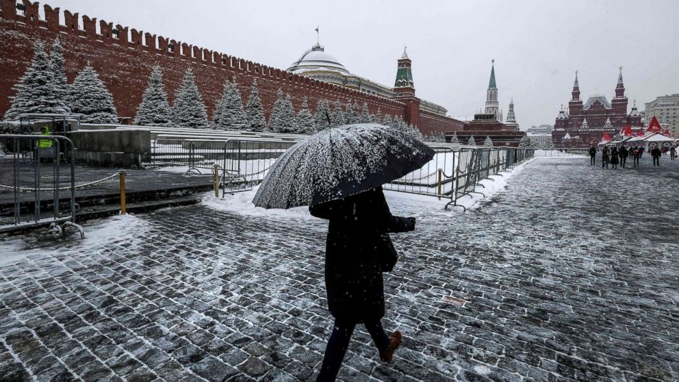 PHOTO: A woman with an umbrella walks on Red Square past the Kremlin after a night of heavy snowfall in Moscow on Dec. 6, 2018.