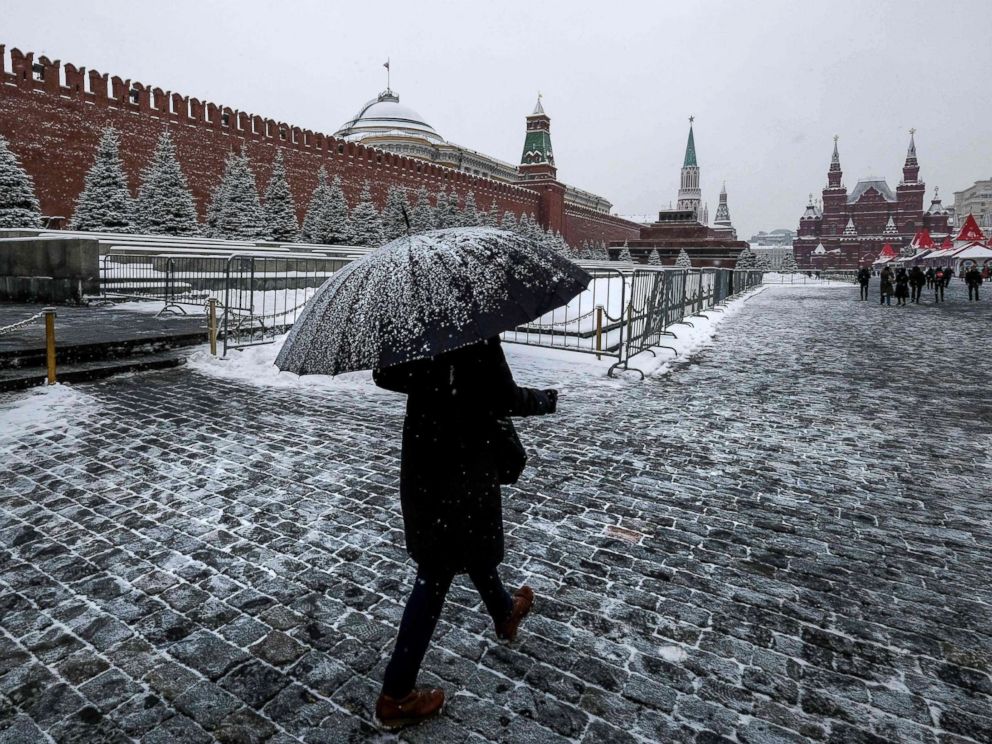 PHOTO: A woman with an umbrella walks on Red Square past the Kremlin after a night of heavy snowfall in Moscow on Dec. 6, 2018.