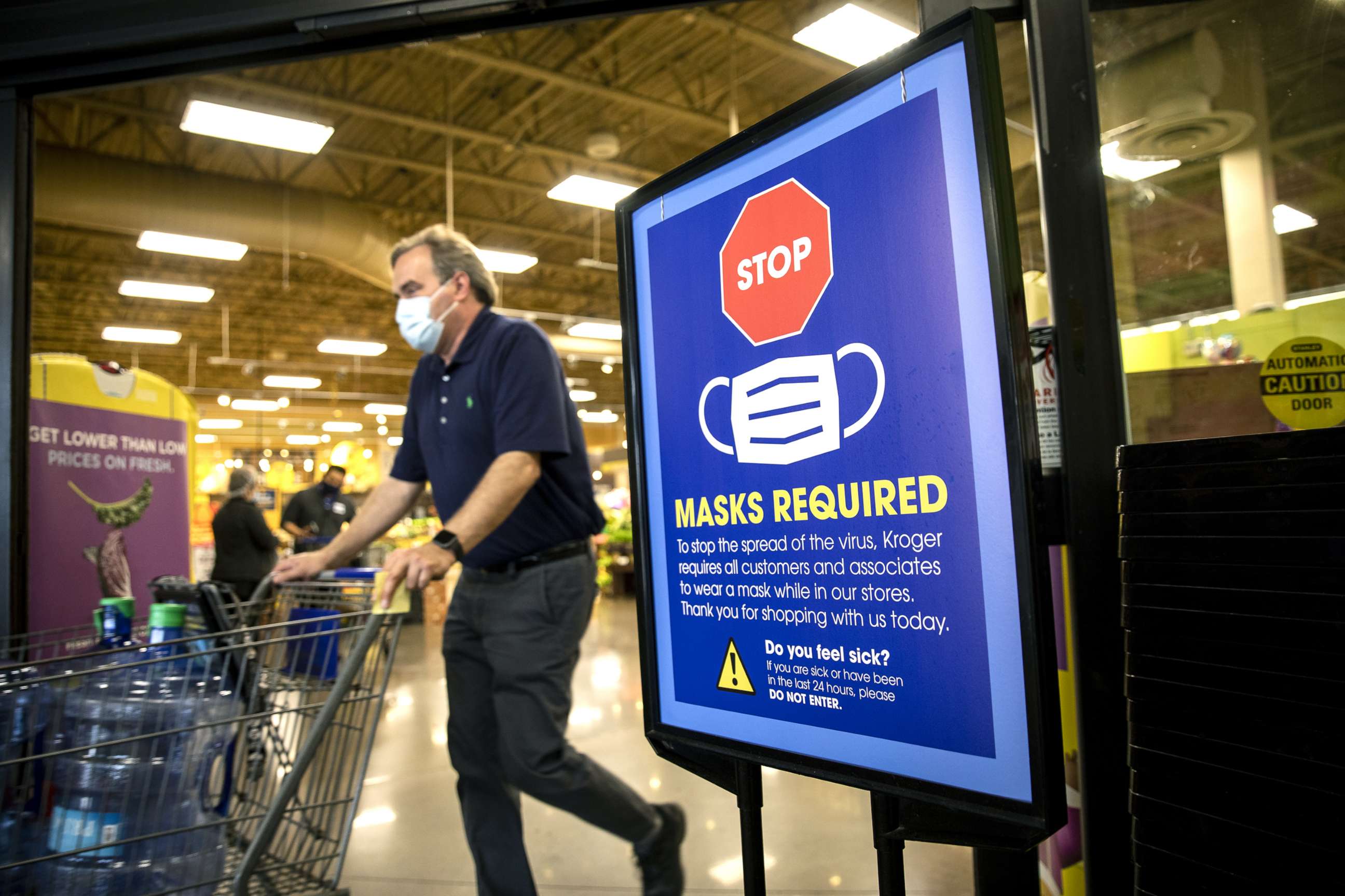 PHOTO: A "Mask Required" sign at the entrance to a Kroger Co. grocery store in Houston, March 10, 2021. 