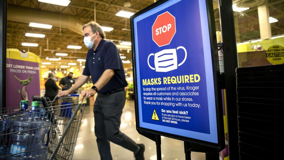 PHOTO: A "Mask Required" sign at the entrance to a Kroger Co. grocery store in Houston, March 10, 2021. 