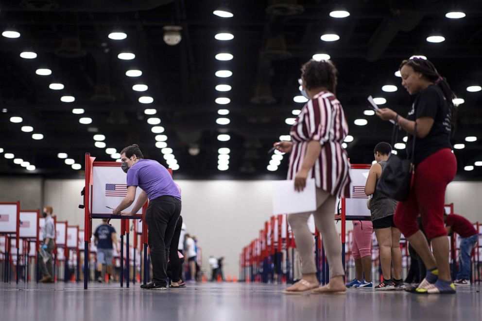 PHOTO: Voters make their way through the polling process during the primary election held at the Kentucky Exposition Center in Louisville,  Ky., June 23, 2020. 