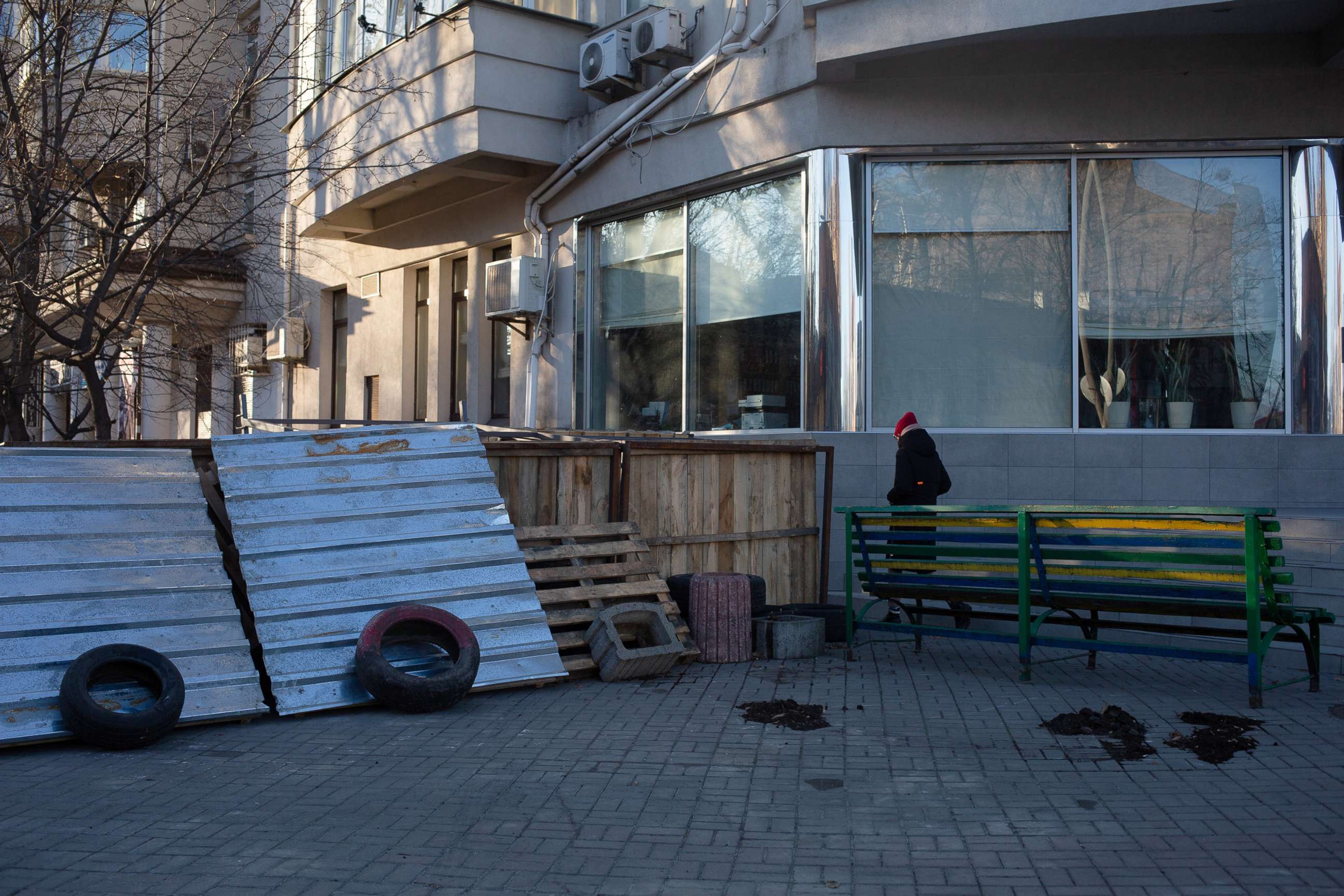 PHOTO: A pedestrian passes a makeshift barricade, Feb. 28, 2022, in Kyiv, Ukraine.