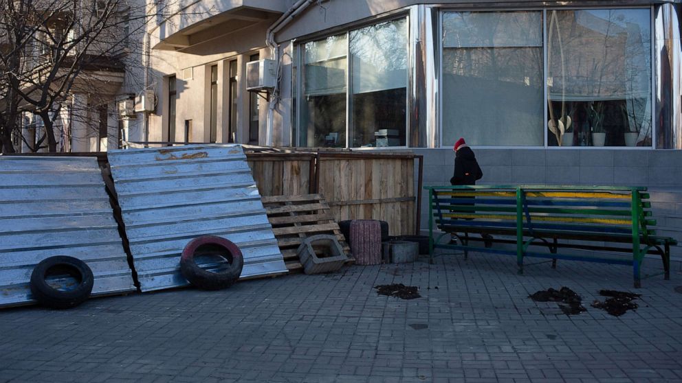 PHOTO: A pedestrian passes a makeshift barricade, Feb. 28, 2022, in Kyiv, Ukraine.