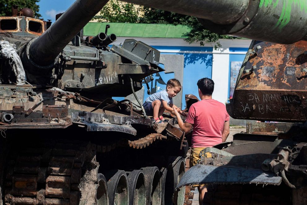 PHOTO: A boy plays on top of a Russian tank destroyed by Ukrainian forces in the center of Kyiv, Ukraine, Sept.  2, 2022.