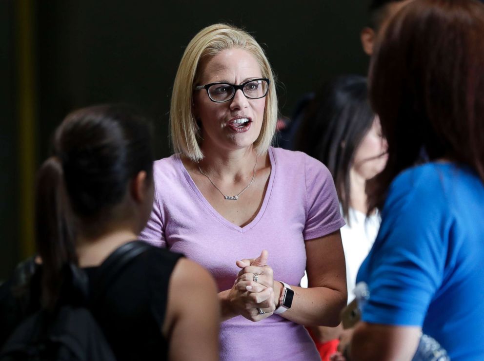 PHOTO: US Deputy Kyrsten Sinema, candidate for the senator, speaks with volunteers in Phoenix, August 21, 2018.