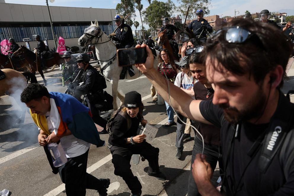 PHOTO: Demonstrators run away from mounted police officers dispersing demonstrators during a No Kings Day protest against President Donald Trump's policies, in Los Angeles, June 14, 2025.  